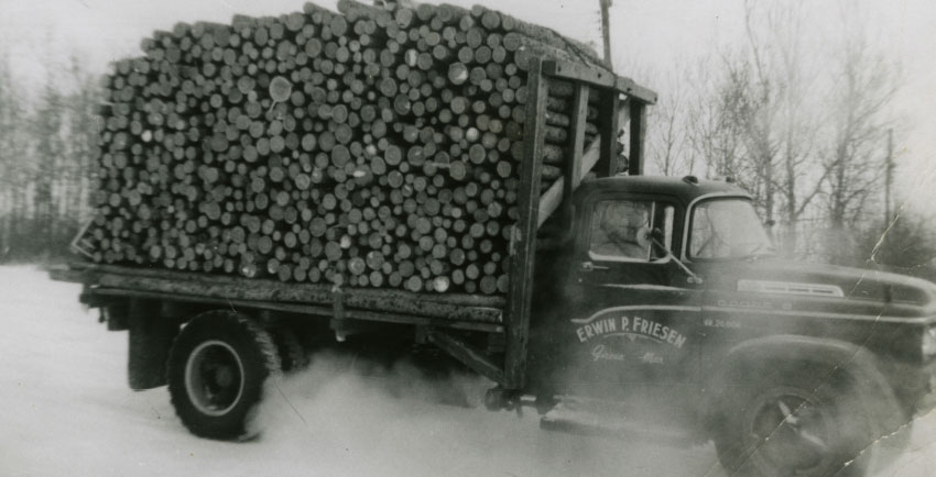 An Old Photo of a Truck Hauling Lumber